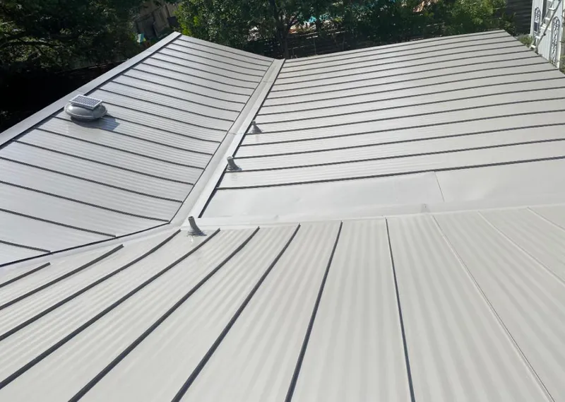 Solar attic fan installed on a metal roof for Roof Ventilation in Indianola
